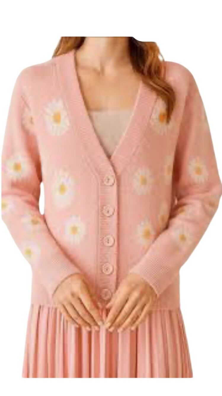 Floral pink knit cardigan features a charming all-over white and yellow daisy pa